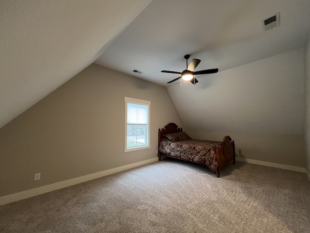 unfurnished bedroom with carpet flooring, ceiling fan, and vaulted ceiling