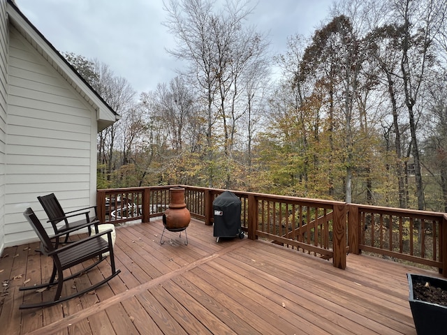 wooden terrace featuring a grill