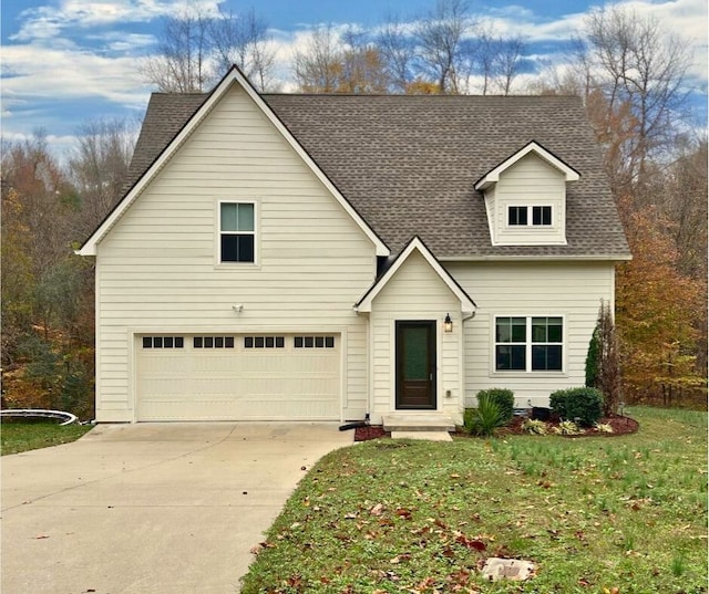 view of front of property featuring a front lawn and a garage