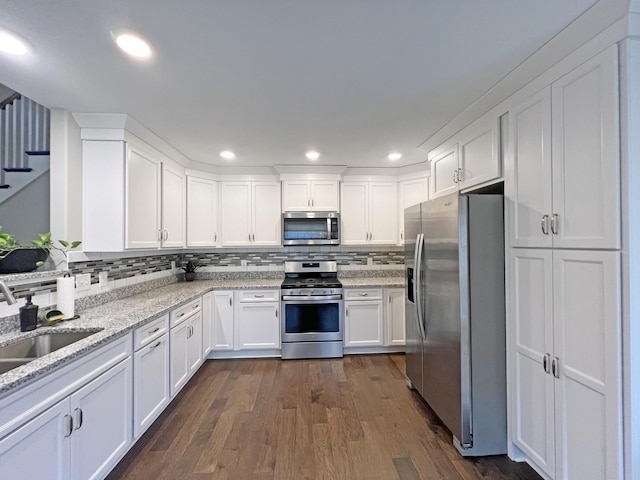 731 Hogan Rd, Clarksville, TN 37043 - kitchen with appliances with stainless steel finishes, white cabinetry, dark wood-style floors, a sink, and recessed lighting