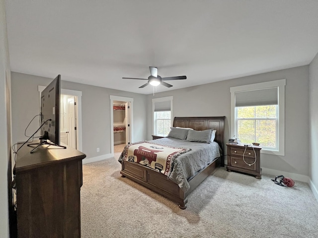 731 Hogan Rd, Clarksville, TN 37043 - carpeted bedroom featuring baseboards, a walk in closet, a ceiling fan, and ensuite bath