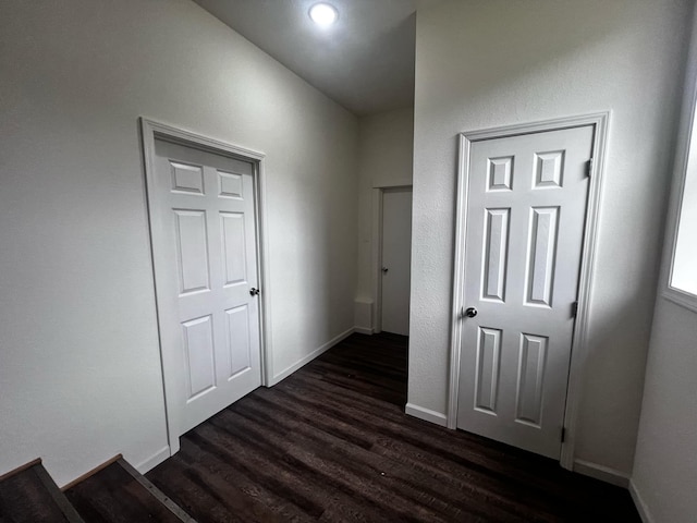 corridor with dark wood-type flooring