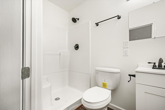 bathroom with vanity, toilet, and walk in shower