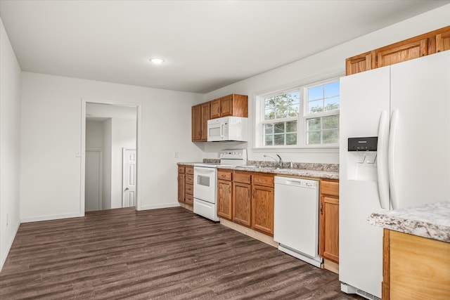 kitchen featuring white appliances, sink, and dark hardwood / wood-style flooring