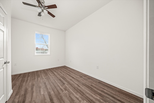 unfurnished room with dark hardwood / wood-style floors, vaulted ceiling, and ceiling fan