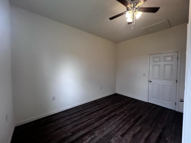 empty room with dark hardwood / wood-style flooring and ceiling fan