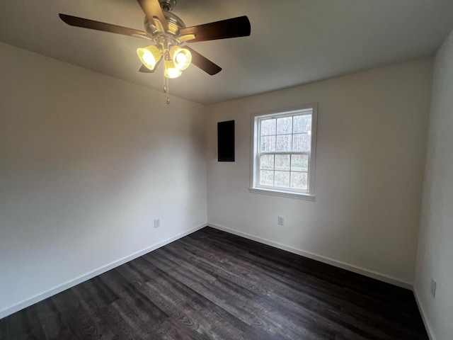 unfurnished room with ceiling fan and dark wood-type flooring