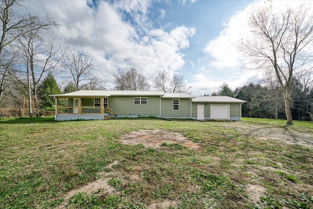 back of property with a yard, a porch, and a garage