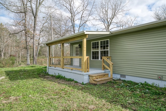 view of side of property with a lawn