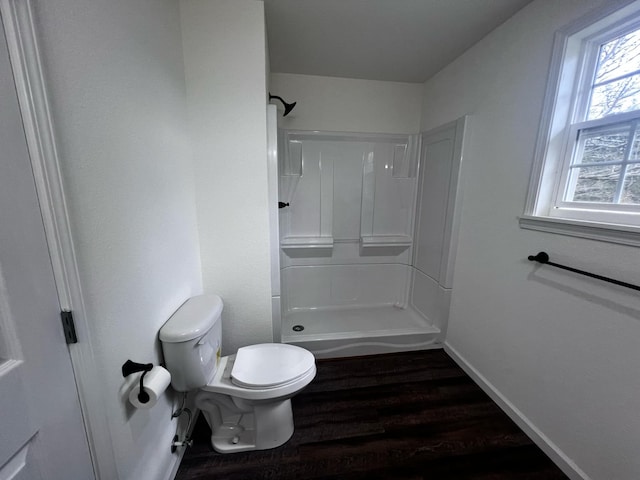 bathroom featuring toilet, walk in shower, and hardwood / wood-style flooring