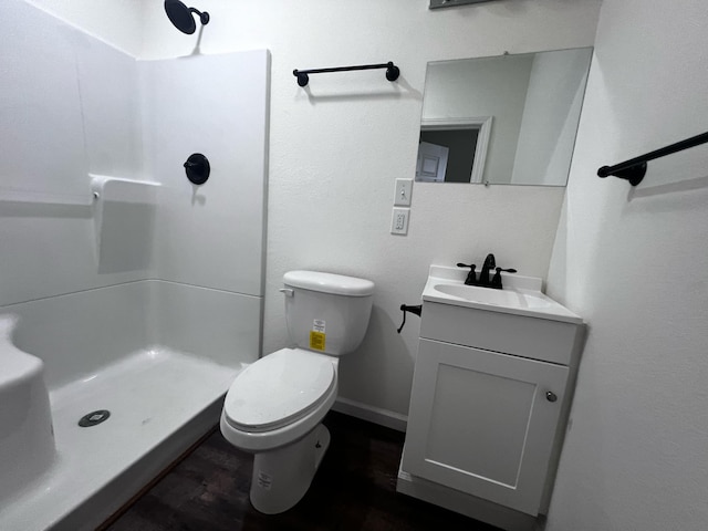 bathroom with vanity, toilet, and a shower