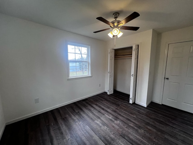 unfurnished bedroom with dark hardwood / wood-style flooring, a closet, and ceiling fan