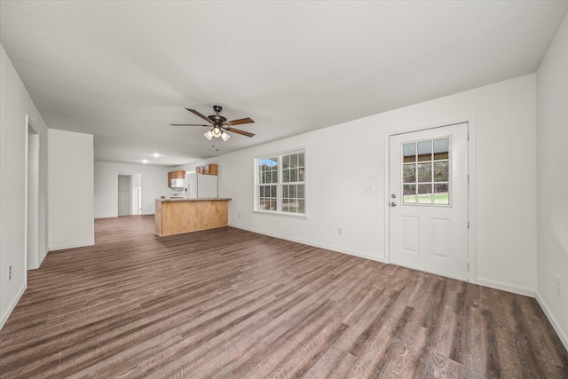 unfurnished living room featuring ceiling fan and hardwood / wood-style flooring