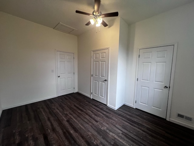 unfurnished bedroom with ceiling fan and dark hardwood / wood-style flooring