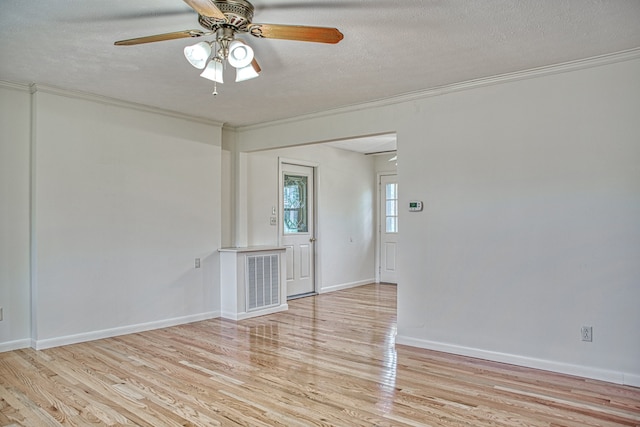 unfurnished room featuring a textured ceiling, light wood-type flooring, ceiling fan, and ornamental molding