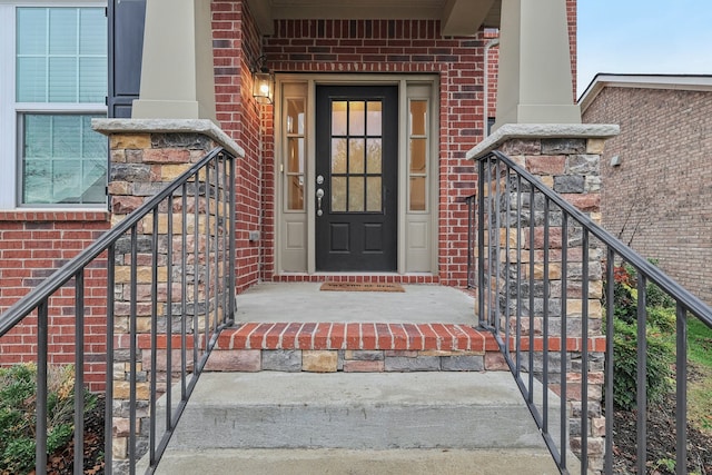 view of exterior entry with a porch