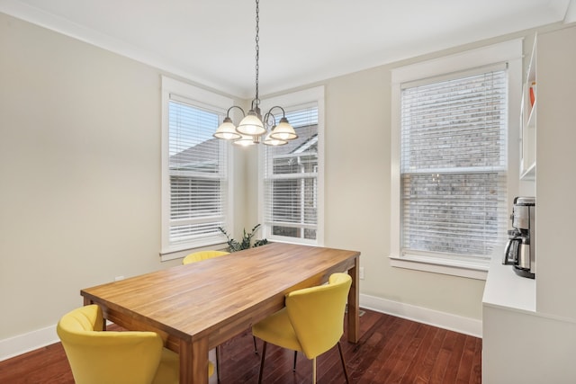 dining area with dark hardwood / wood-style flooring and a notable chandelier