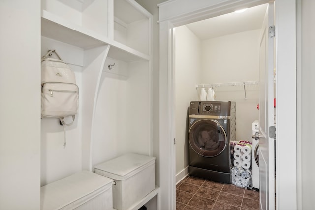 washroom featuring dark tile patterned floors and washer / dryer