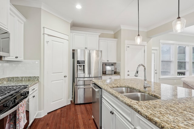 kitchen with white cabinets, appliances with stainless steel finishes, dark hardwood / wood-style flooring, and sink