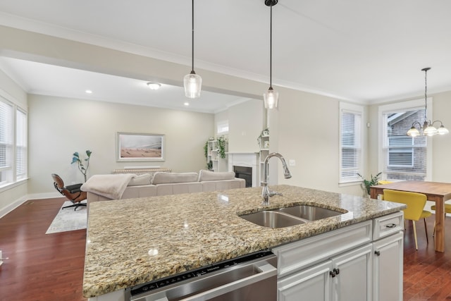 kitchen featuring dishwasher, dark hardwood / wood-style floors, light stone counters, and sink