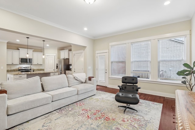 living room featuring hardwood / wood-style flooring and crown molding