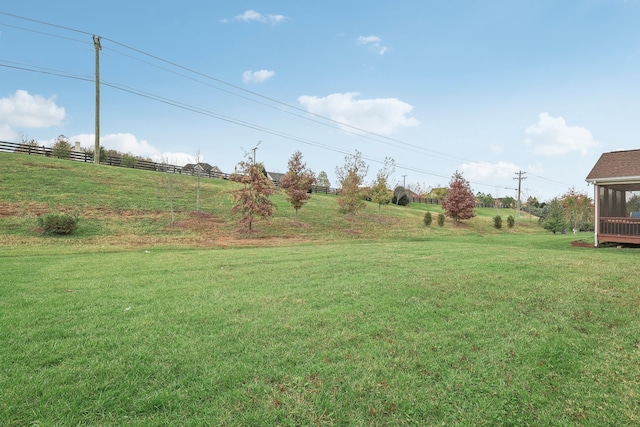 view of yard with a sunroom and a rural view