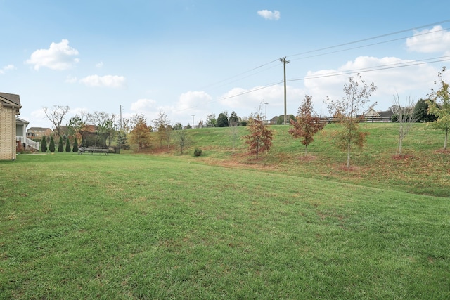 view of yard featuring a rural view and a trampoline