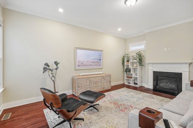 living room featuring dark hardwood / wood-style floors and crown molding