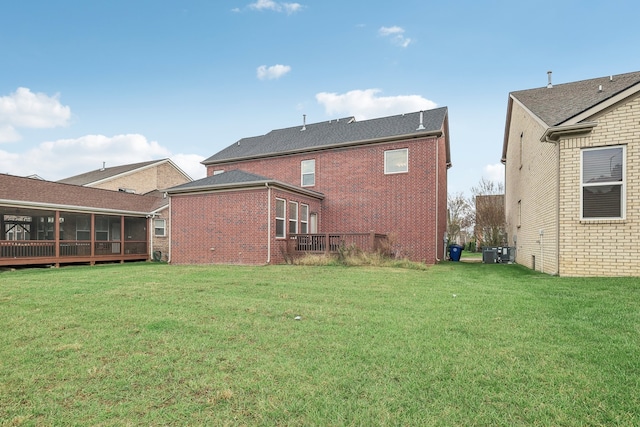 back of property with a lawn and central AC unit