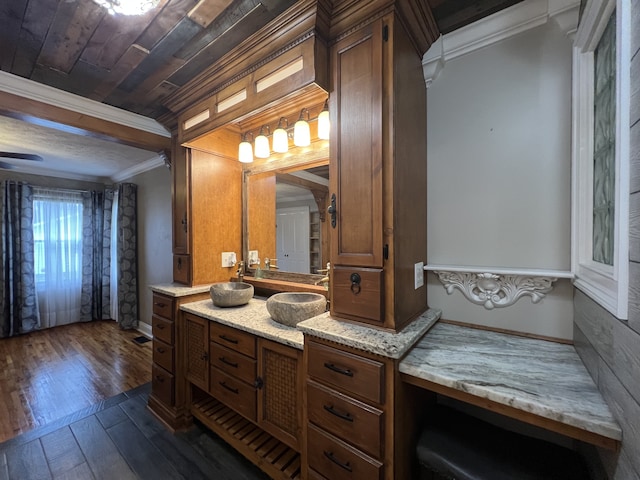 bathroom featuring crown molding, hardwood / wood-style floors, and vanity