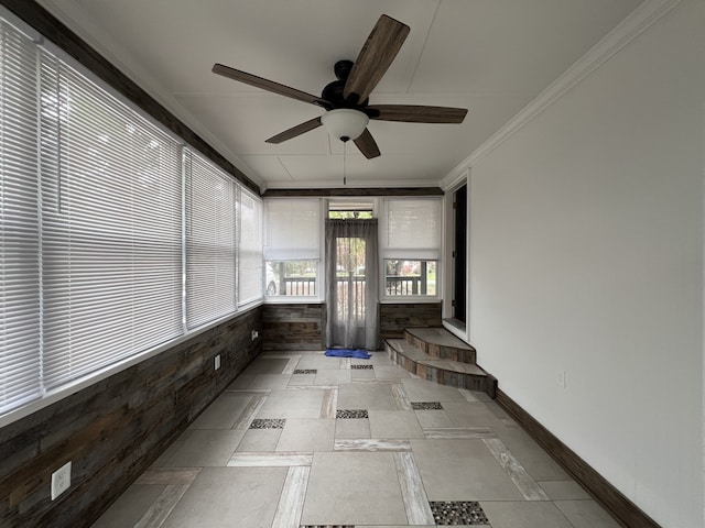 unfurnished sunroom with ceiling fan