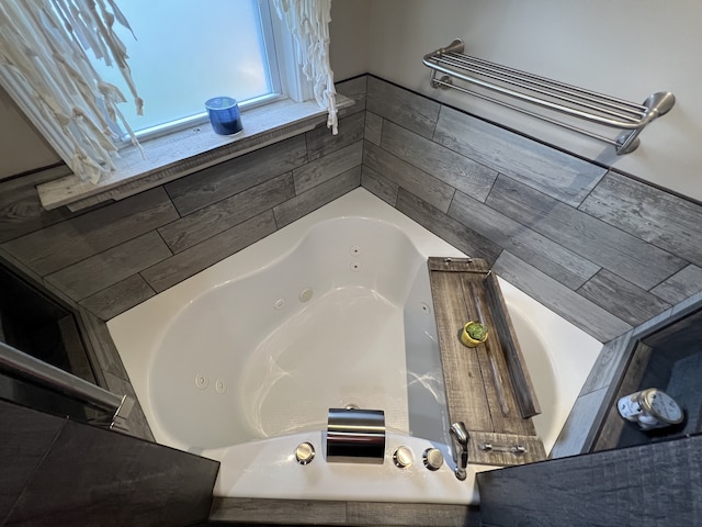 bathroom featuring a relaxing tiled tub