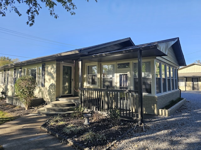 view of front of property featuring a sunroom