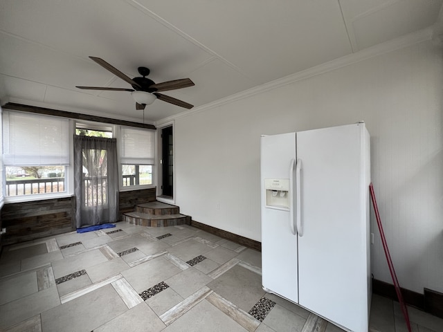 interior space with ornamental molding and ceiling fan