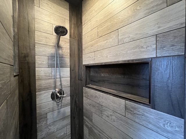 room details with a tile shower and wooden walls