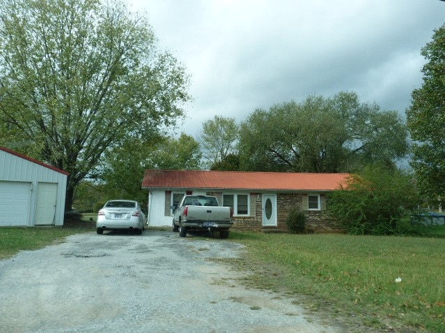 ranch-style home with a front lawn