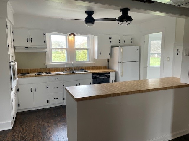 kitchen featuring white appliances, dark wood-type flooring, white cabinets, sink, and ceiling fan