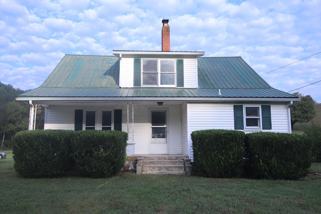 60 Riddle Rd, Shelbyville, TN 37160 - view of front of home featuring covered porch, a front lawn, a chimney, and a metal roof