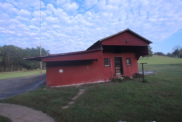 view of outdoor structure featuring a lawn