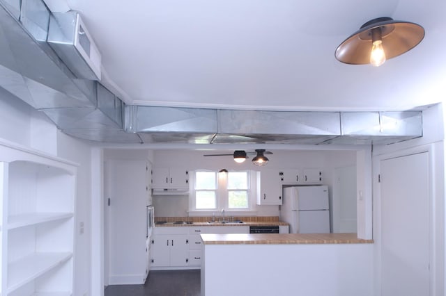 60 Riddle Rd, Shelbyville, TN 37160 - kitchen featuring white appliances, a peninsula, white cabinets, under cabinet range hood, and light countertops