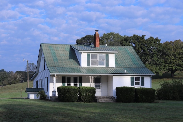 60 Riddle Rd, Shelbyville, TN 37160 - view of front of home with covered porch, a chimney, a front lawn, and a metal roof