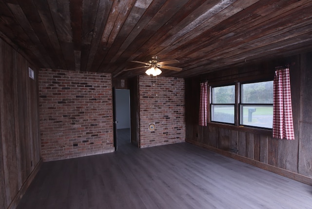 unfurnished room with wood-type flooring, wooden walls, and brick wall