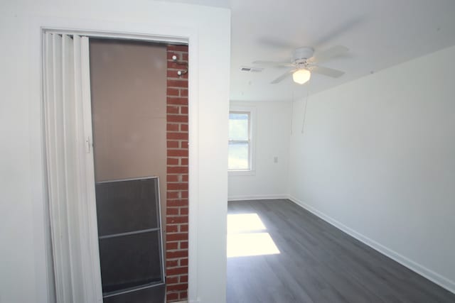 spare room with ceiling fan and dark hardwood / wood-style flooring