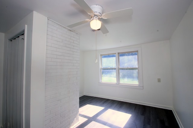 empty room featuring dark hardwood / wood-style floors and ceiling fan