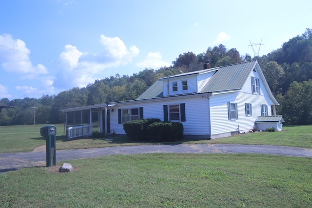 60 Riddle Rd, Shelbyville, TN 37160 - view of front of home with a front lawn, a metal roof, a chimney, and asphalt driveway