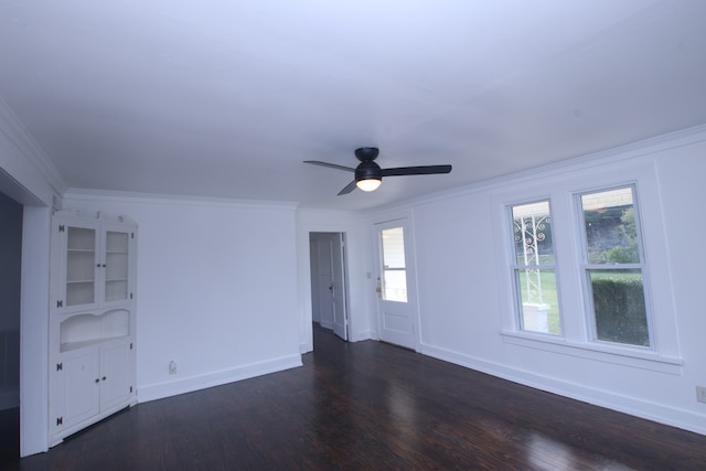 empty room with dark hardwood / wood-style floors, ceiling fan, and ornamental molding