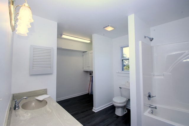 full bathroom with hardwood / wood-style flooring, toilet, shower / tub combination, and sink