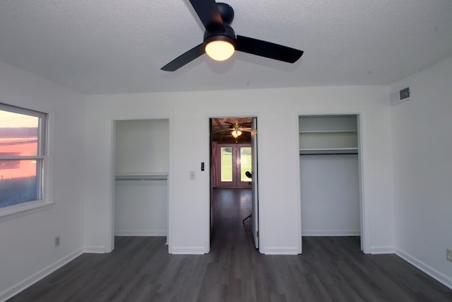 unfurnished bedroom featuring ceiling fan, dark hardwood / wood-style floors, and a textured ceiling