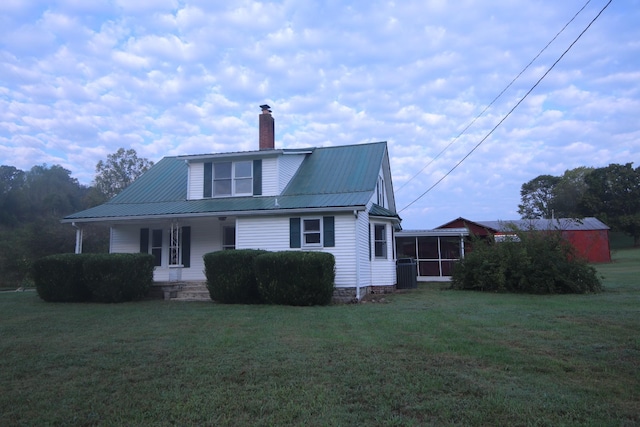 60 Riddle Rd, Shelbyville, TN 37160 - view of front of house with a sunroom, a front yard, a porch, and a chimney