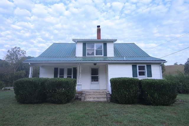 view of front of home with a porch and a front yard